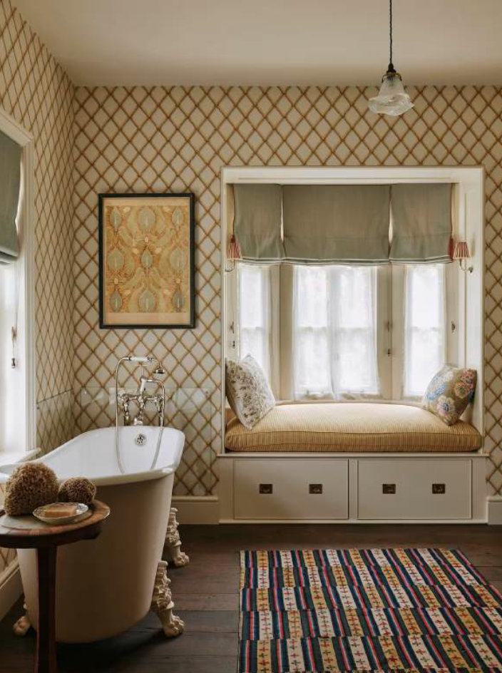 Max Rollitt used a cushioning, upholstered window seat, curtains and a distinctively patterned rug to offset the harder surfaces in this garden cottage while in this Hampshire house he installed a picture rail